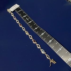 NWT gold tone 7.5” bracelet with multi coloured gemstones and crystal design